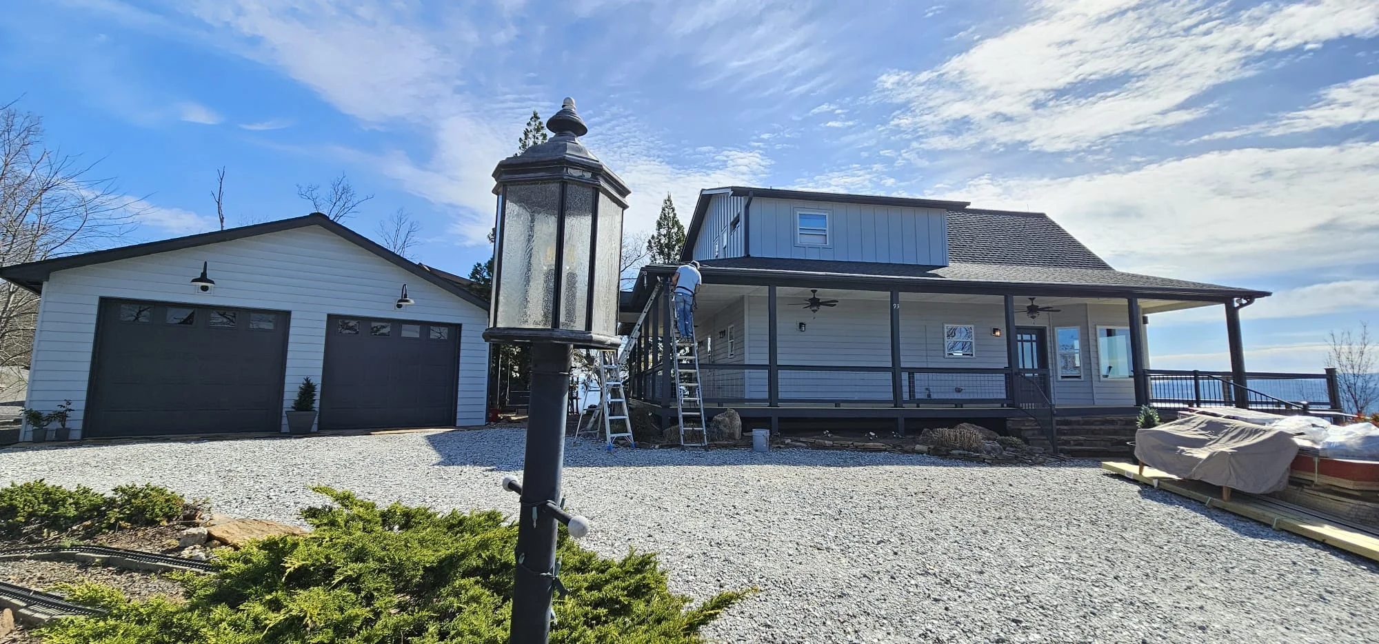 Modern farmhouse with newly installed black-framed windows and screened porch addition